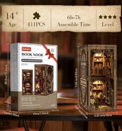 Kit de manualidades para book nook de madera con láminas precortadas a láser, instrucciones y accesorios sobre una mesa.